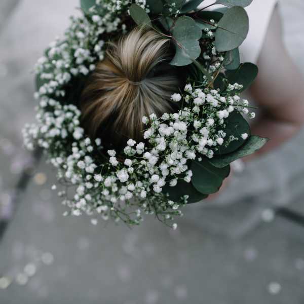 Floral crown with white baby's breath and eucalyptus on a person's hair