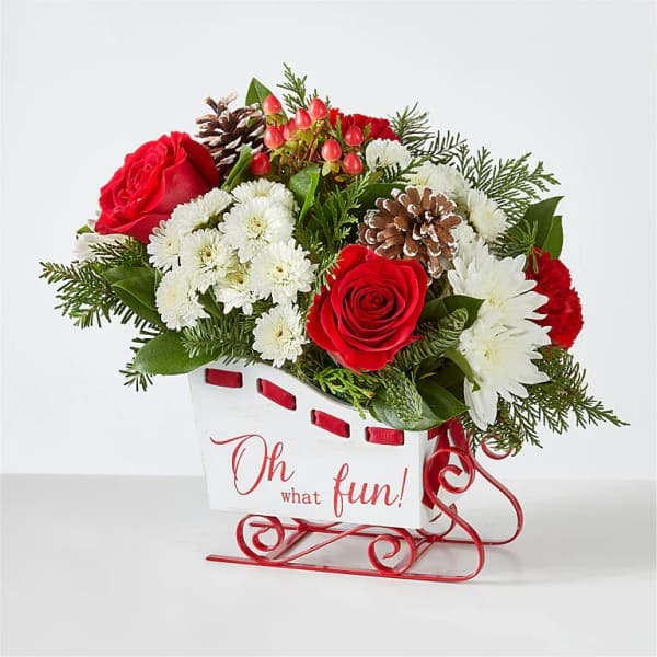 Red roses and white daisies in a white sleigh container