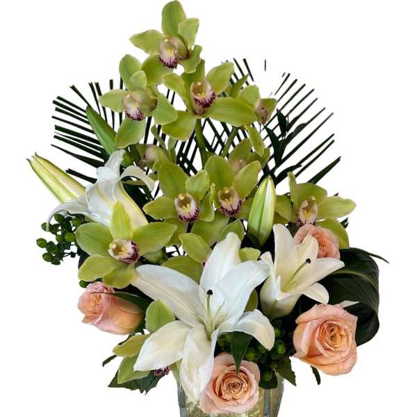 Orchid and lily arrangement with peach roses in a square glass vase
