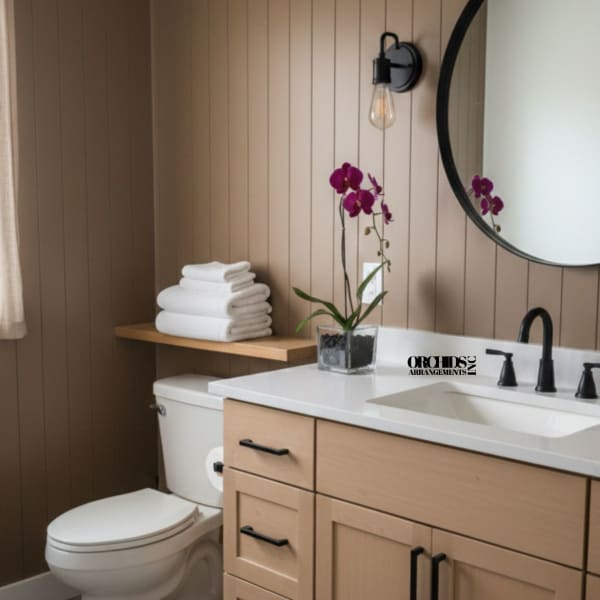 Purple orchid in a square glass vase on a bathroom counter