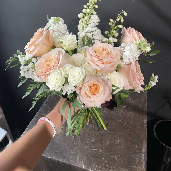 Peach and white rose bouquet with white filler flowers