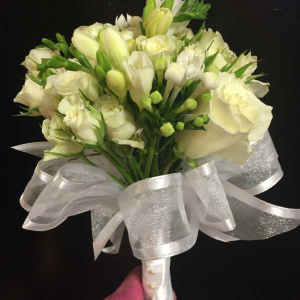 White flower bouquet with a large silver ribbon bow