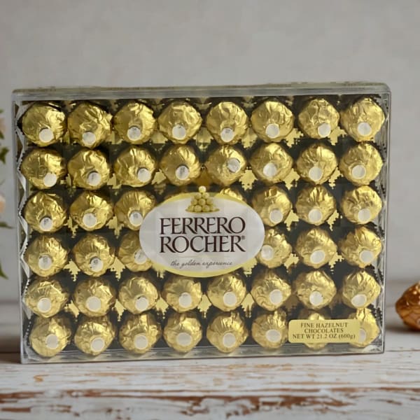 Box of Ferrero Rocher chocolates beside a small potted flower arrangement