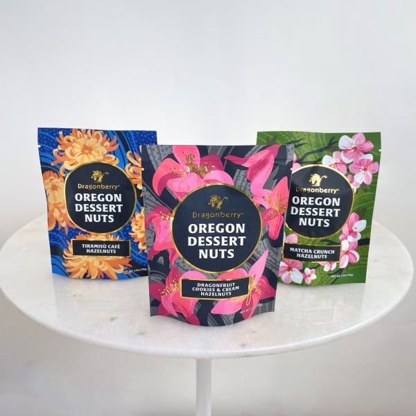 Three bags of Oregon Dessert Nuts on a round white table
