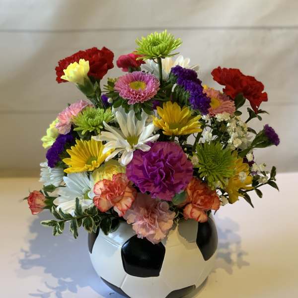Mixed flowers arranged in a soccer ball vase