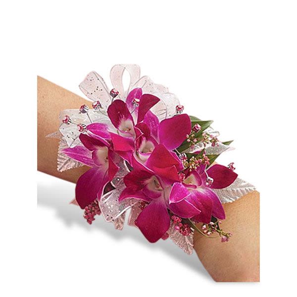 Pink orchid wrist corsage with sheer white ribbon accents on a person's arm.