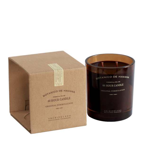 Brown boxed candle beside an amber glass jar candle