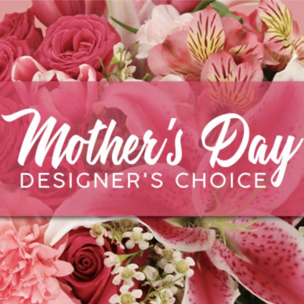 Pink floral arrangement with roses and lilies behind a Mother's Day banner
