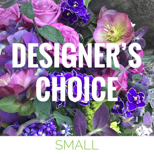 Purple floral arrangement with roses and hellebore blooms