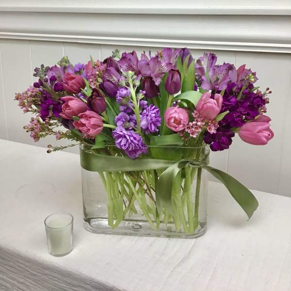Pink and purple tulips with alstroemeria in a glass vase