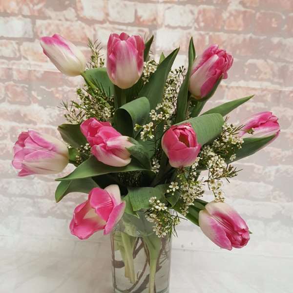Pink tulips arranged in a clear glass vase