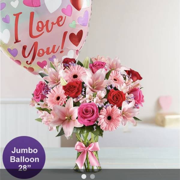 Pink and red flower bouquet with a heart balloon reading I Love You