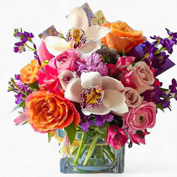 Colorful bouquet with roses, orchids, and purple flowers in a glass vase
