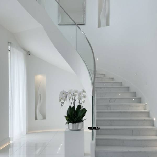 White orchid plant in a silver pot on a pedestal in a modern stairwell
