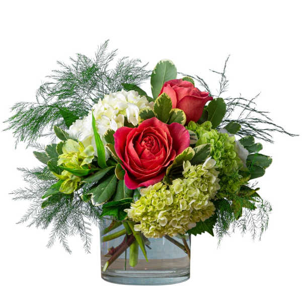 Red roses and white hydrangeas in a clear glass vase