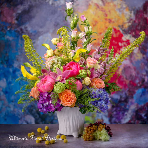 Colorful mixed flower arrangement in a white vase