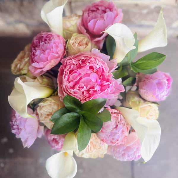 Pink peonies and white calla lilies in a bouquet
