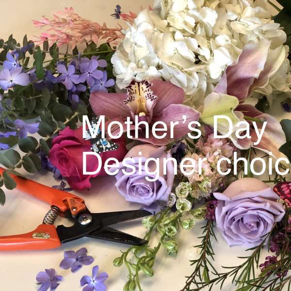 Mixed floral arrangement with roses, orchids, hydrangea, and butterflies