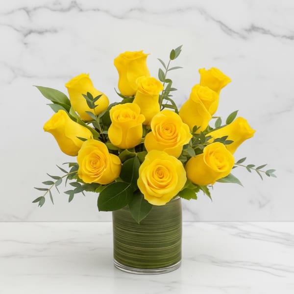 Yellow roses arranged in a green glass vase