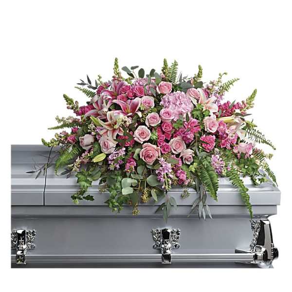 Pink floral casket spray on a silver casket