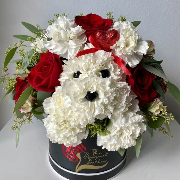 Red roses and white carnations arranged in a black hat box with a heart accent