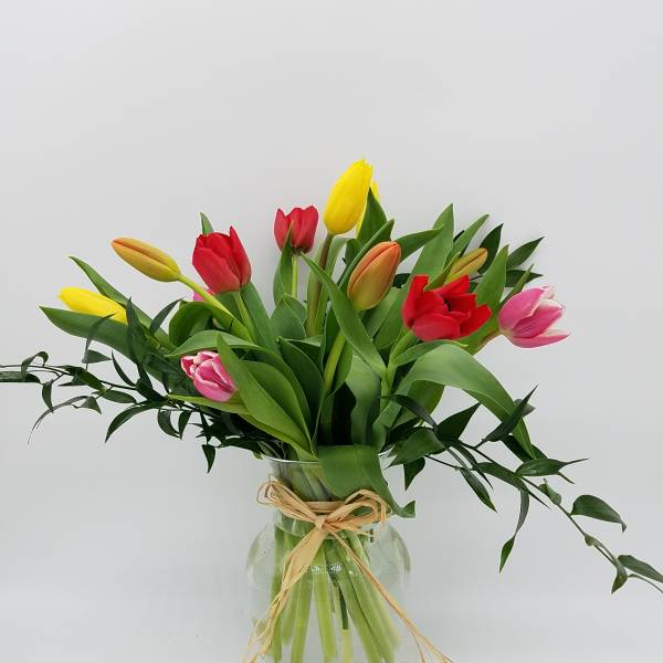 Bouquet of multicolored tulips in a glass vase