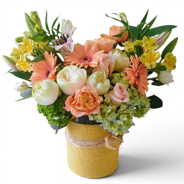 Peach and white mixed bouquet in a burlap-wrapped vase