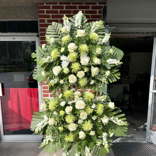 Tall standing floral spray with white roses and green chrysanthemums