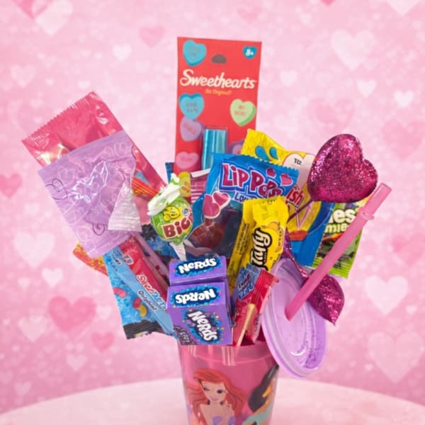 Candy bouquet in a pink cup with heart decorations