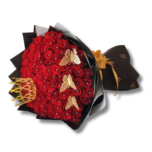 Bouquet of red roses wrapped in black paper with gold accents
