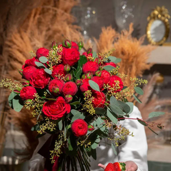 Bouquet of red roses with eucalyptus and a red ribbon