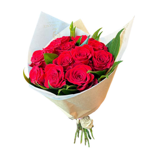 Bouquet of red roses wrapped in pale paper