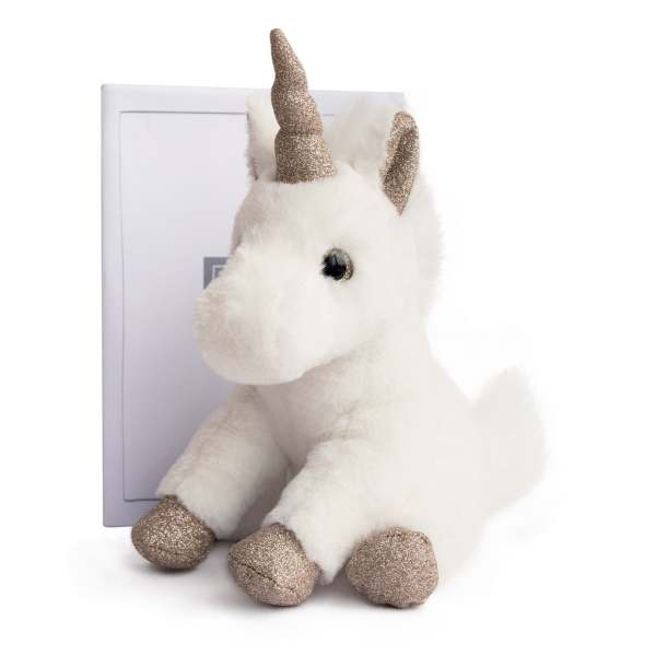 Plush white unicorn with glittery gold horn and hooves sitting in front of a box