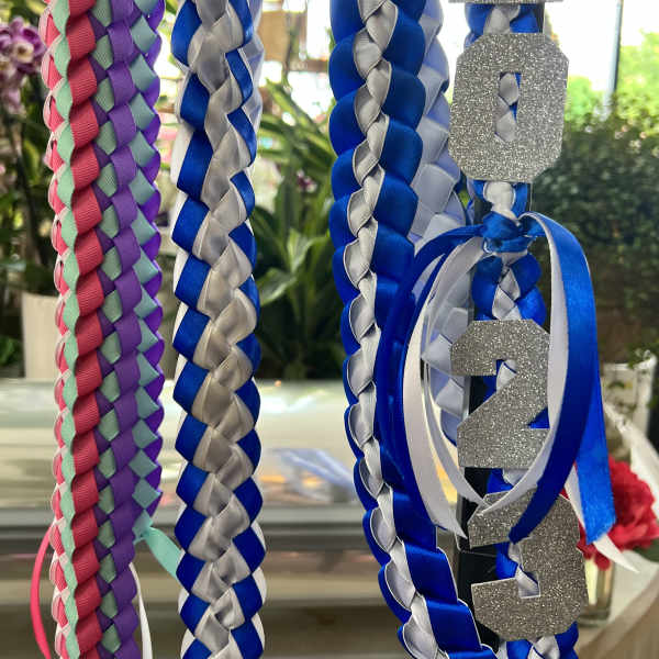 Braided blue, silver, and pink ribbons with glittery 2024 numbers