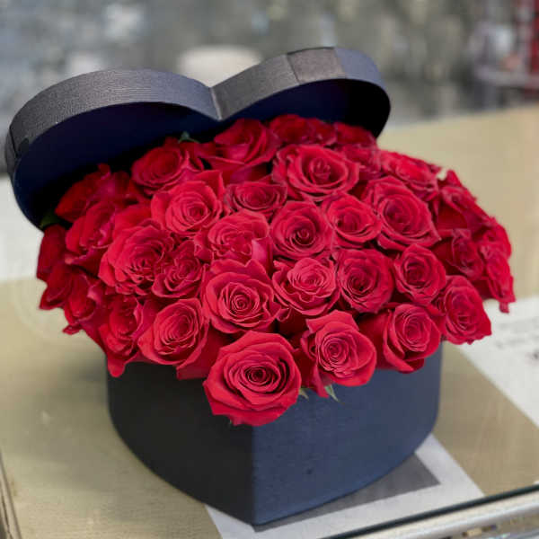 Heart-shaped box filled with red roses