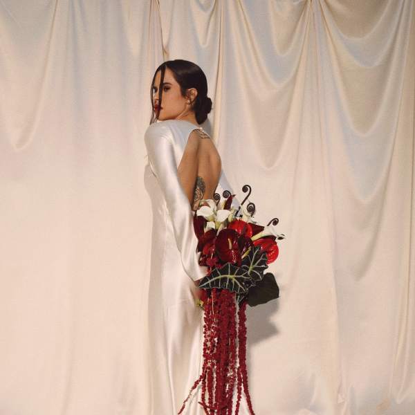 Bride in a white gown holding a red and white bouquet