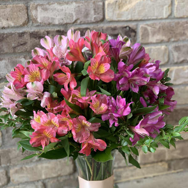 Bouquet of pink and purple alstroemeria in a glass vase