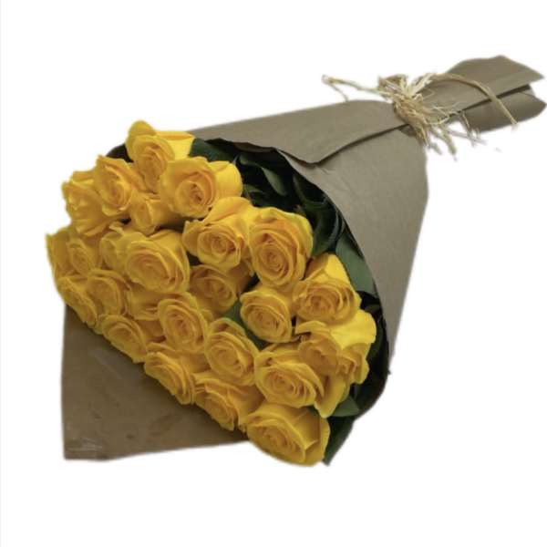 Bouquet of yellow roses wrapped in brown paper