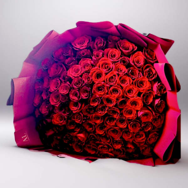 Large bouquet of red roses wrapped in pink paper
