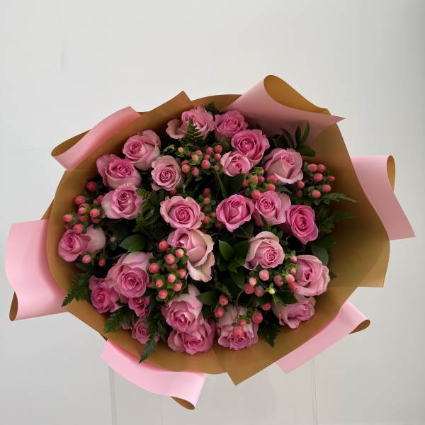 Bouquet of pink roses wrapped in brown and pink paper