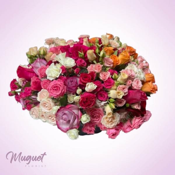 Large bouquet of multicolored roses on a pale pink background