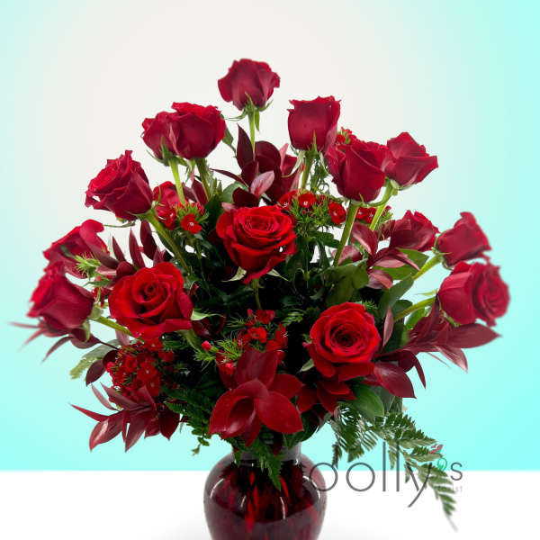 Red roses arranged in a dark glass vase