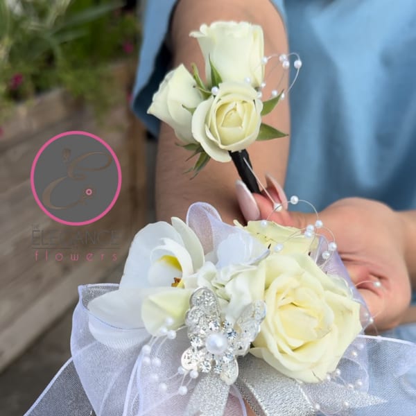 White rose corsages with pearl accents and silver ribbon