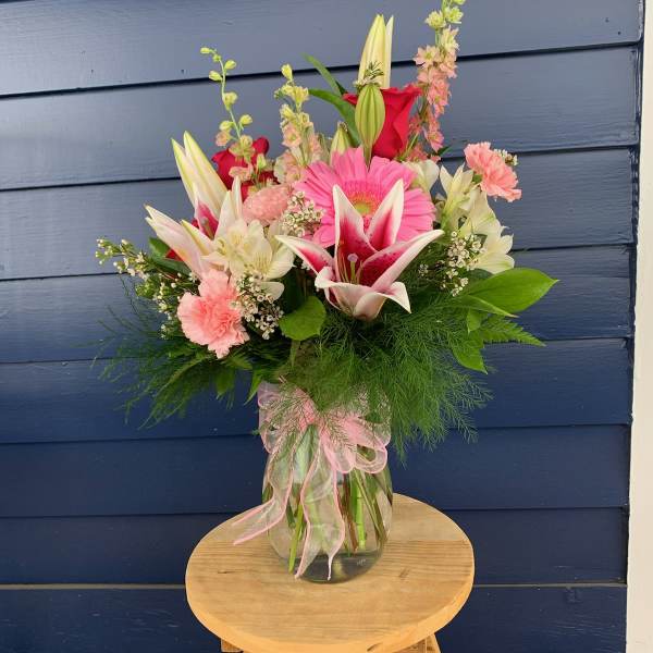 Mixed bouquet of pink and white flowers in a glass vase