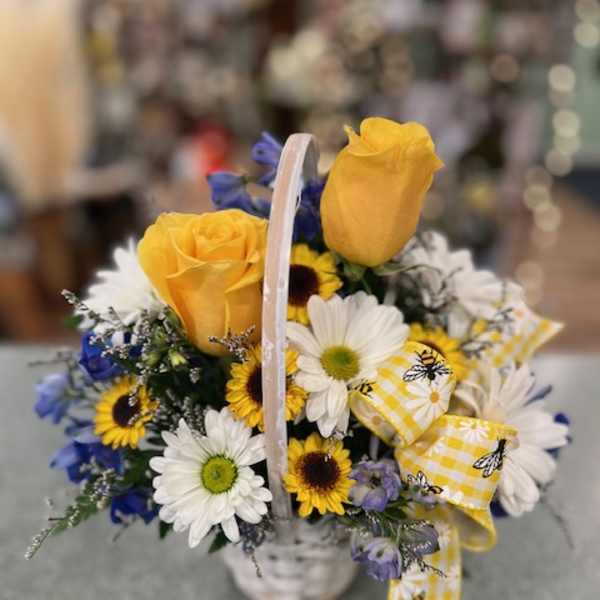 Basket of yellow roses and daisies with a yellow ribbon