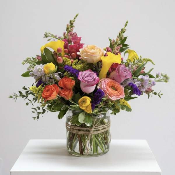 Mixed bouquet of colorful flowers in a glass vase