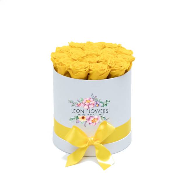 Yellow roses in a round white box with a yellow ribbon