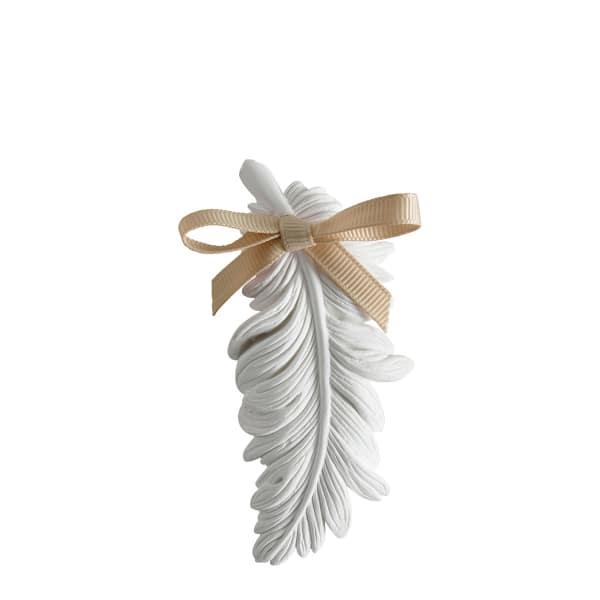 White feather ornament tied with a beige ribbon