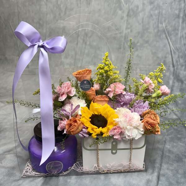 Flower gift set with sunflowers, roses, and carnations in a clear bag