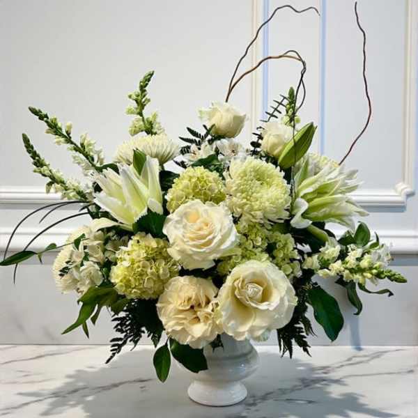 Cream and white floral arrangement in a white vase